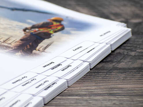 Binder tabs with printing on the body of the sheet